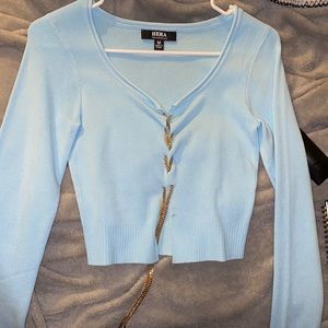 Light blue long sleeve with chains on the middle